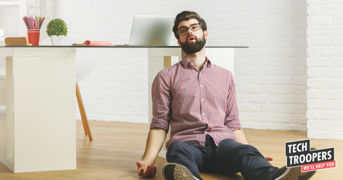 Exhausted man sitting on floor